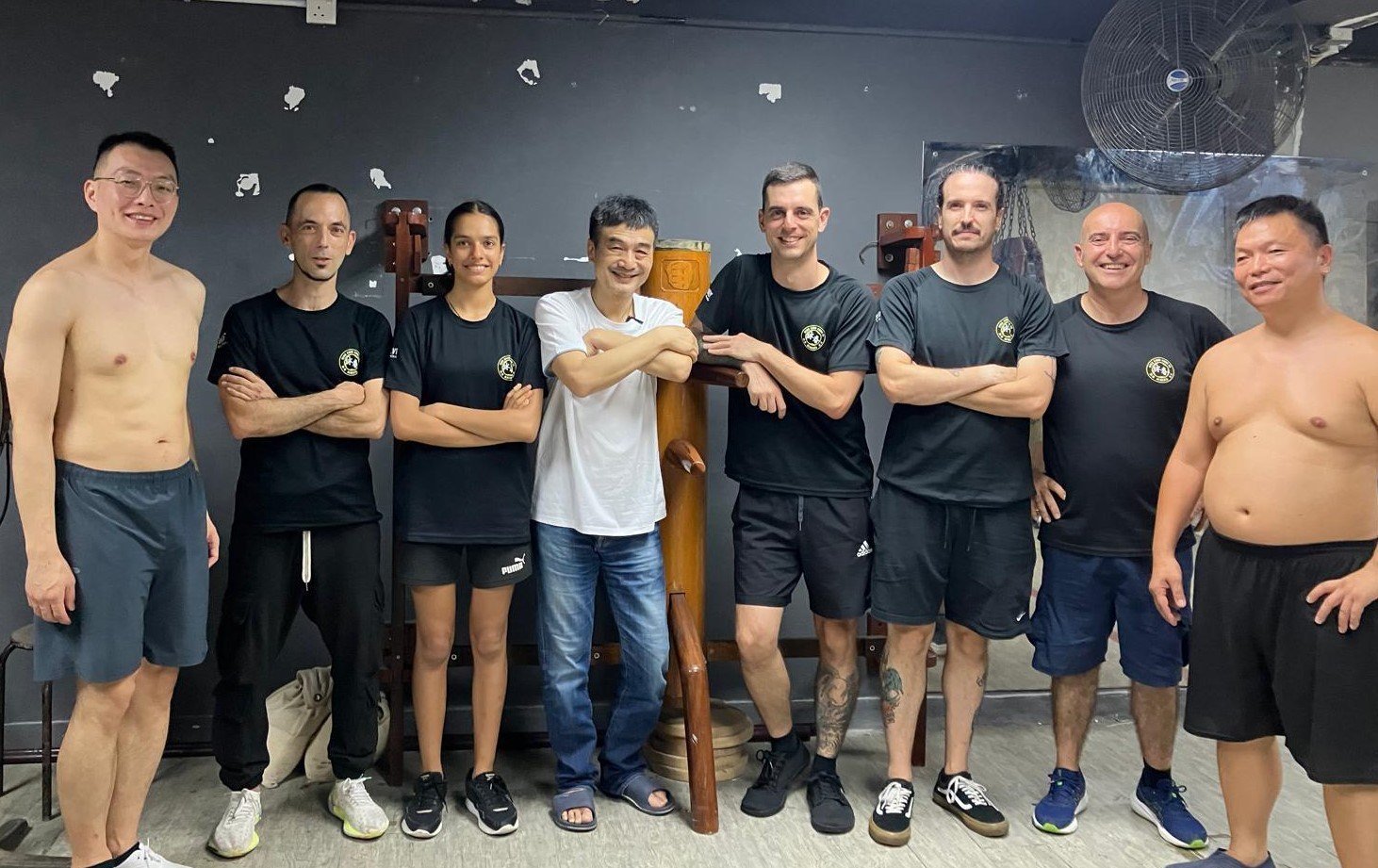 Grupo de practicantes con Li Hang Cheong en su escuela de Hong Kong, junto a un muñeco de madera.